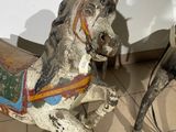 two horses that are standing next to each other on the floor