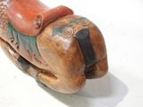 a small wooden horse with a saddle on it ' s back