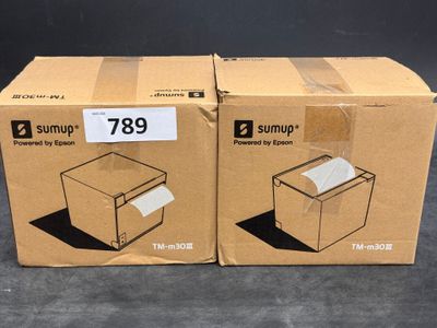 two boxes of paper sitting on top of a table next to each other