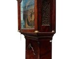 a tall wooden grandfather clock with a glass door