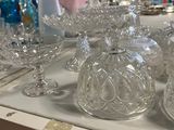 a lot of glass dishes and glasses on the table