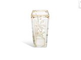 a glass vase with a white flower inside of it