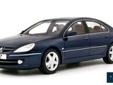 the blue car is parked on the white surface with a white background