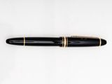 a close up of a pen on a white surface with a white background