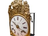 a gold clock with roman numerals on it