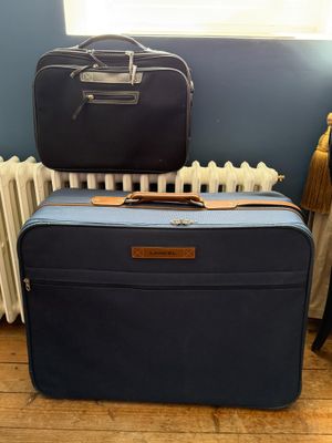 deux valises posées l'une sur l'autre par terre