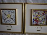 two framed paintings of a couple of paintings on a white surface