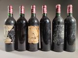 six bouteilles de vin sont alignées sur une table