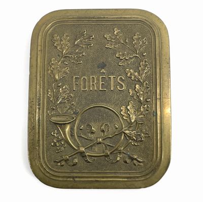 a gold plate with a skull and crossbones on it