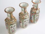 three vases that are sitting on a white surface