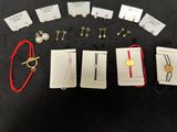 several pairs of earrings and bracelets are laid out on a table