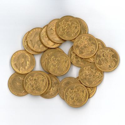 a pile of gold coins sitting on a white surface