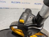 a close up of a black and yellow wheel with a yellow handle