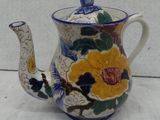 an image of a teapot with flowers on it