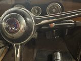 dashboard of an old car with a steering wheel and gauges
