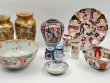 many different types of vases and bowls on the table