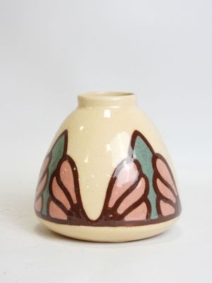 a white vase with a pink and green design on it