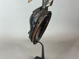 a close up of a sculpture of a bird on a stand