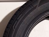 a close up of a tire on the side of a white wall