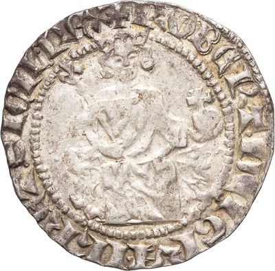 une vieille pièce d'argent surmontée d'une couronne