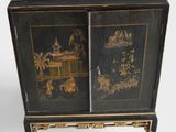 a black cabinet with a black and gold design on it