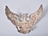 a silver bird with a crown on it ' s head