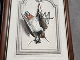 a picture of a picture of a bird hanging on a wall