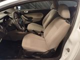the interior of a white car with beige seats and a steering wheel