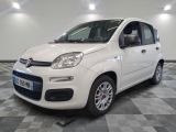 la petite voiture blanche est garée sur un carrelage à carreaux