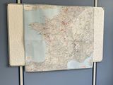 a map hanging on the wall of a room