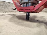 a close up view of a red motorcycle on the ground