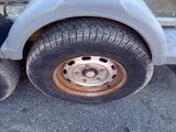 a close up of a flat tire on a trailer
