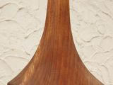 a close up of a wooden vase on a table