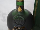 a bottle of liquor that is sitting next to a box