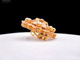 a close up of a gold ring with pearls on it