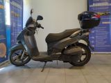 a scooter that is parked in front of a wall