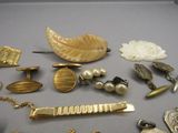 many different types of jewelry on display on a table