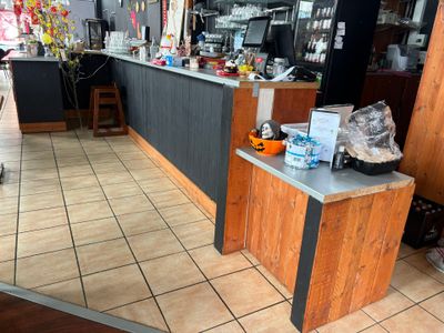 a small counter in a restaurant with a bunch of items on the counter