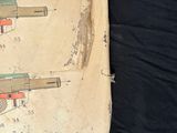 an old book with a drawing of a gun on it