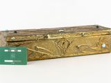a gold box with a credit card in front of it