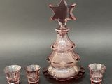 a pink glass christmas tree with a star on top of it