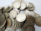 a pile of silver coins sitting on a table