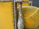 a yellow chair that is sitting in the middle of a room