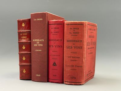 trois livres rouges superposés sur une surface blanche