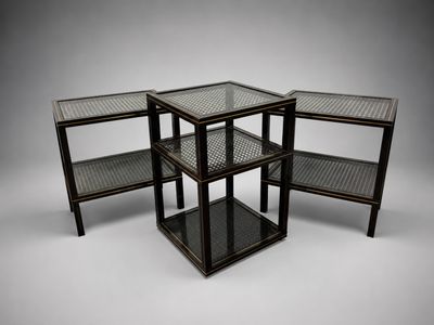 three black metal and glass side tables on a white background