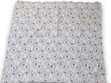 a close up of a pillow with a flower pattern on it