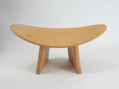 an image of a small wooden bench with a curved seat