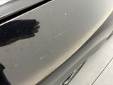 a person ' s hand that is on the door of a car