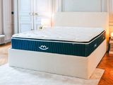 an image of a mattress in a bedroom with a white rug