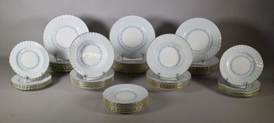 a lot of white and gold plates on a table